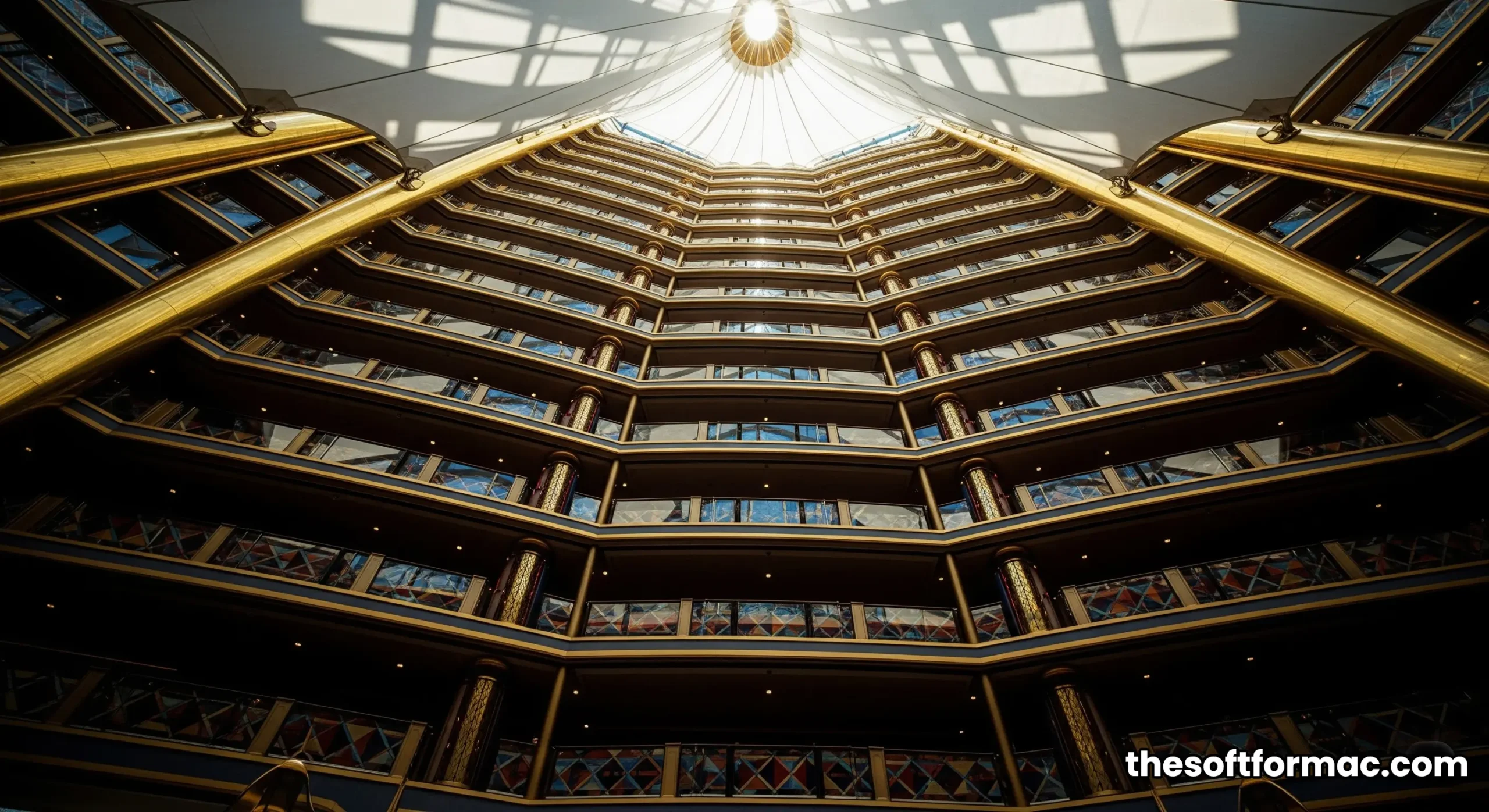 The towering, colorful atrium of the Burj Al Arab Jumeirah, viewed from the ground floor, showcasing its architectural grandeur.